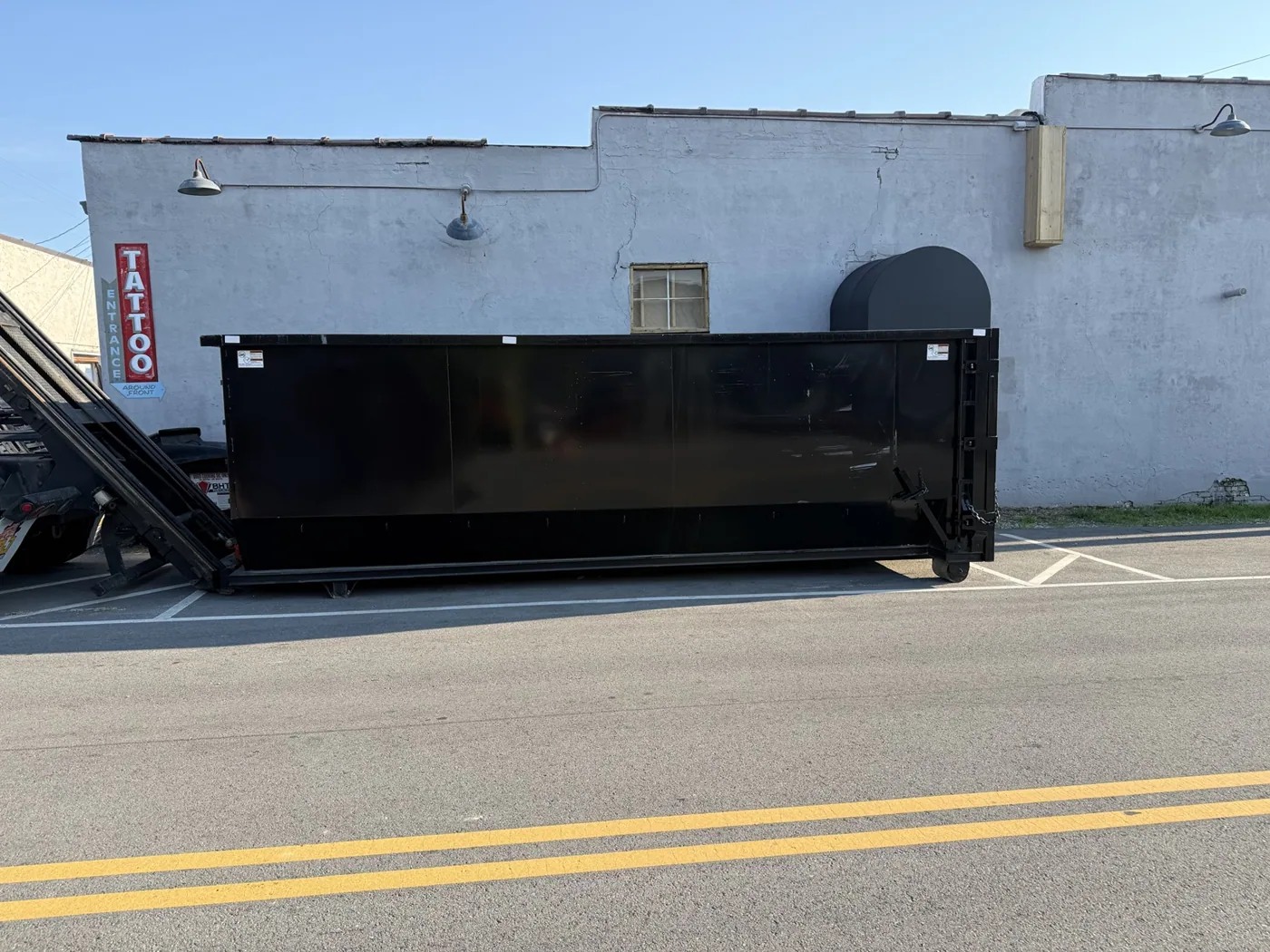 Roll-off dumpster delivered by truck on the street